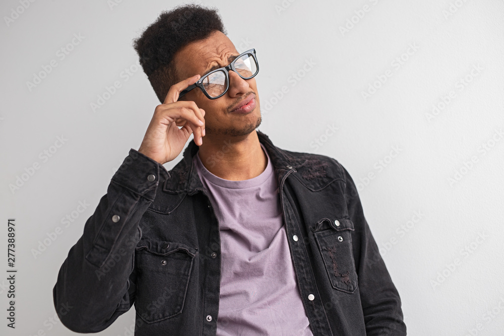 Confident black male in glasses looking away Confident black male in glasses looking away