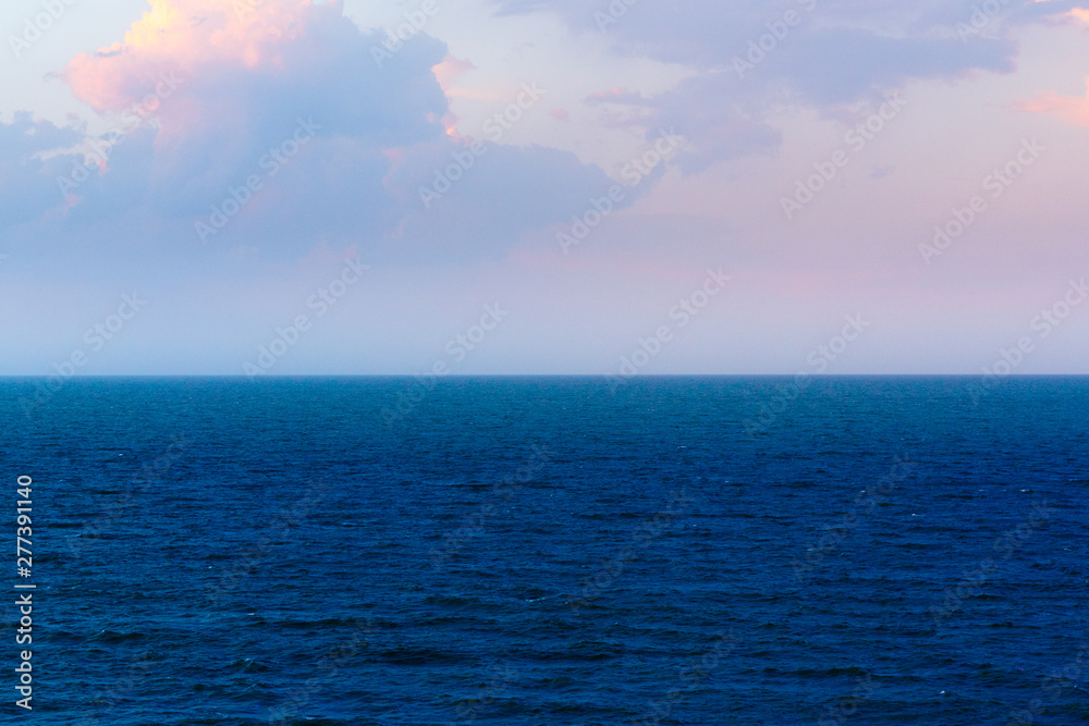 Coastline of the sea in the rays of the setting sun Coastline of the sea in the rays of the setting sun