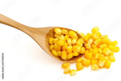 Corn seeds in a wooden spoon isolated on white background