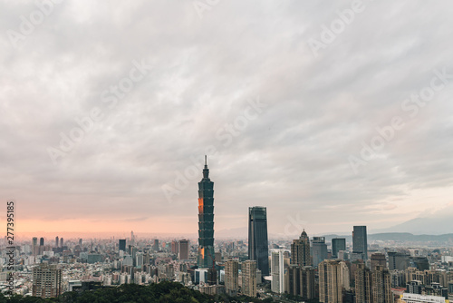 Aerial over Downtown Taipei with Taipei 101 Skyscraper in the dusk from Xiangshan Elephant Mountain in the evening.