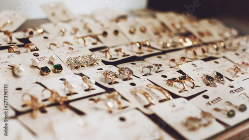 фотографія Kropivnitskiy, Ukraine – 27 May, 2019: luxury gold jewelry earrings background, selective focus