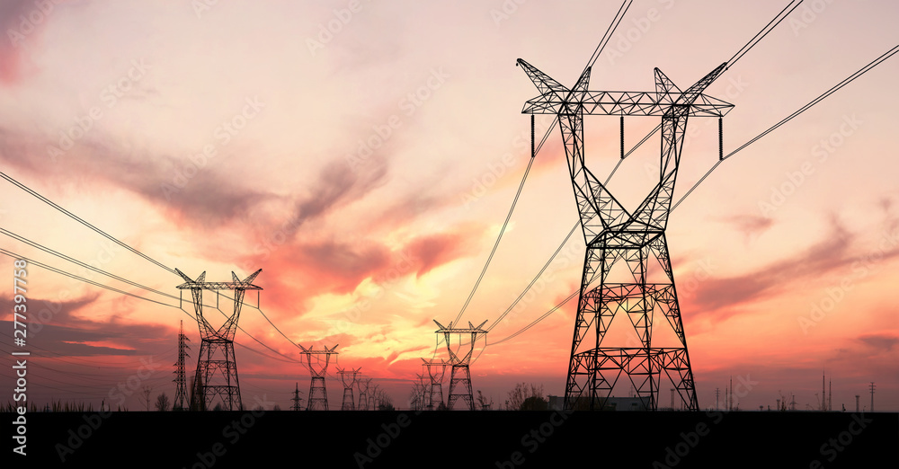 Electricity pylons and lines at dusk.