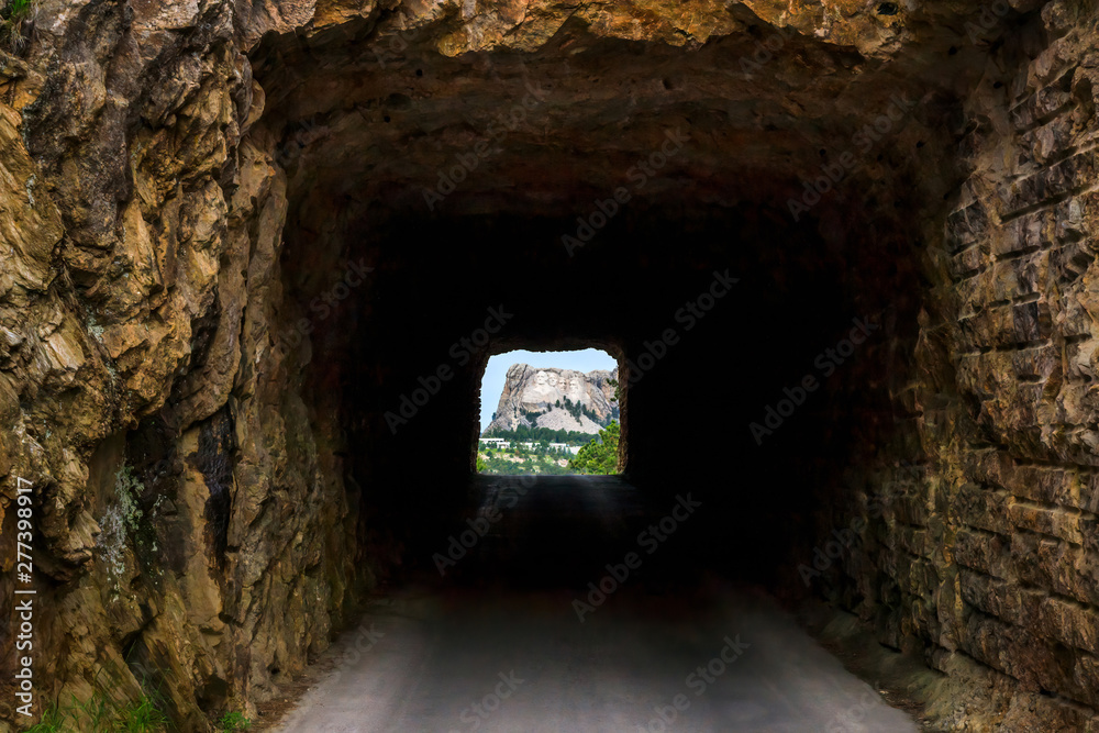 Mount Rushmore framed by tunnel on Iron Mountain Road in the Black Hills of South Dakota, USA
