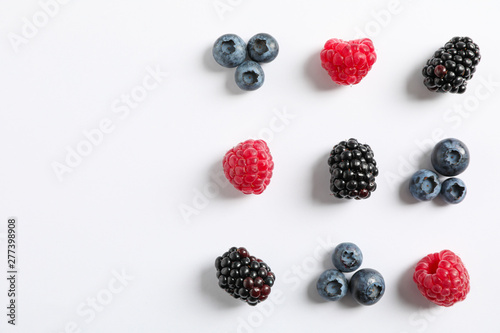 Flat lay composition with berries on white background  space for text