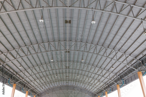 Steel roof structure. Moonlight bulb. Steel structure with roof tiles. Architectural structure of roof. Large roof layout used for industrial plants.