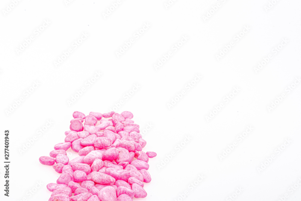 Pink pebbles stone with empty copyspace area for slogan or advertising text message, over isolated white background.