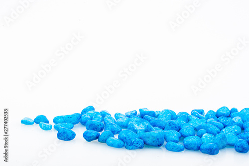 Blue pebbles stone with empty copyspace area for slogan or advertising text message, over isolated white background.