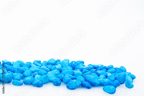 Blue pebbles stone with empty copyspace area for slogan or advertising text message, over isolated white background.