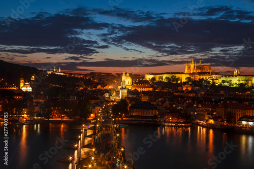 Top view of Prague castle  St. Vitus Cathedral  Vltava river and Charles bridge at night. Prague  Czech Republic