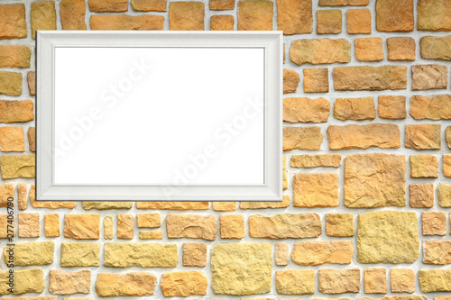 Biały szyld reklamowy na kamiennej ścianie, tekst, napis.