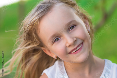  little girl face, green background, close up © erainbow