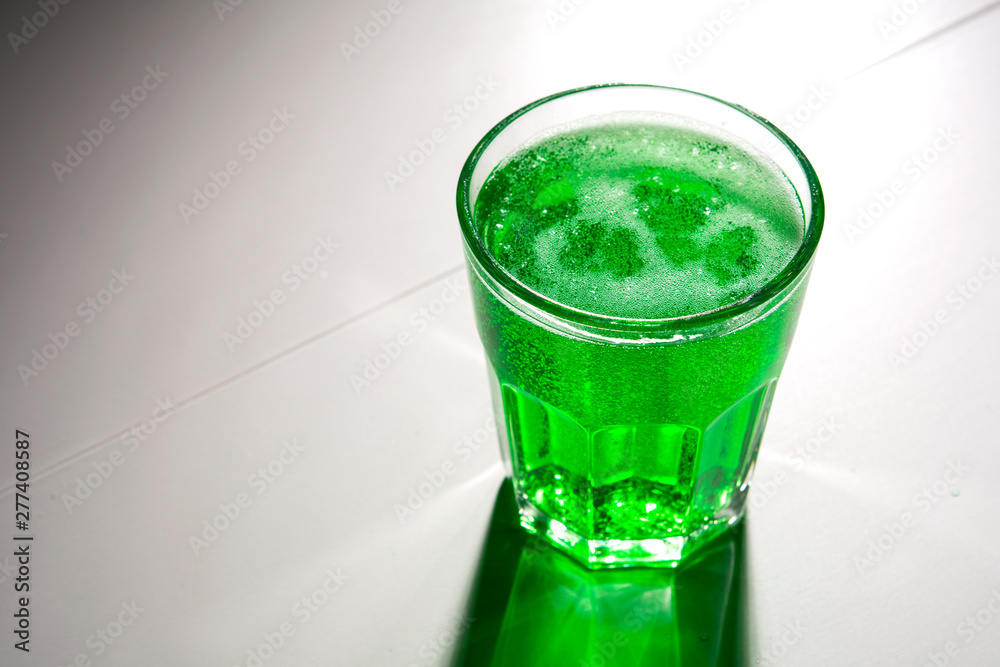 glass with green soda on a white background glass with green soda on a white background