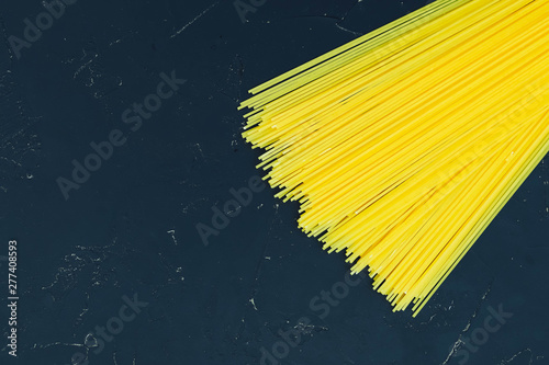 Italian vermicelli spaghetti on a black background.