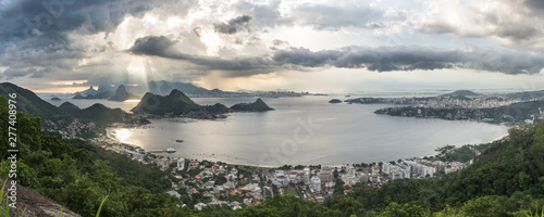 Wide Horizontal Panorama showing São Francisco Beach and Charitas in Niterói and Rio de Janeiro City Mountains During a Magical Sunset with Beautiful Light Rays