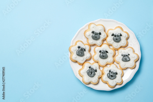 Eid Ad-Adha Mubarak holiday concept - cookies shaped like sheeps, top view photo