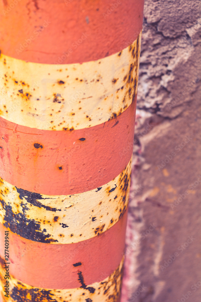 Old rustic Bollard or Traffic pole. Sign for cars with white and red stripes Old rustic Bollard or Traffic pole. Sign for cars with white and red stripes