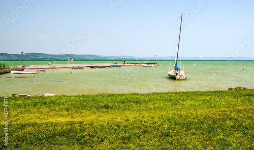 Balatonlelle, Hungary-June 2019. Tourist in the grass in a summer day near the lake of the town in a sunny day. photo