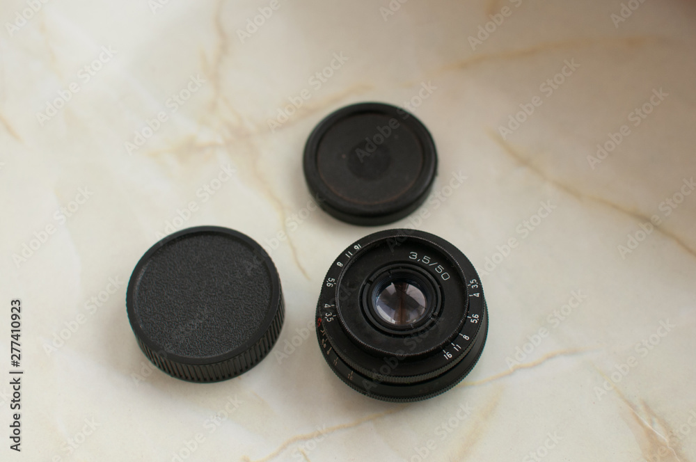 Old black manual lens with black case