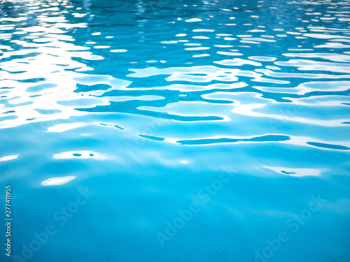 Texture of blue pool water with sun highlights