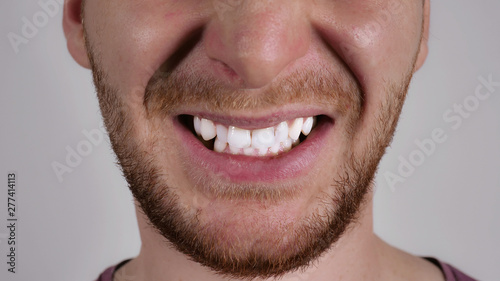 part of face caucasian man. Unrecognizable male with beard anger. Person showing grin