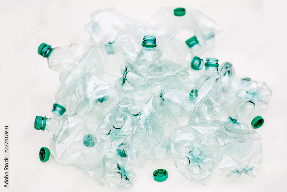 heap of empty crumpled plastic bottles on a white background heap of empty crumpled plastic bottles on a white background