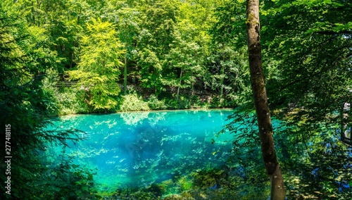 Germany, XXL nature landscape panorama of blue waters of natural spring, called blautopf (blue pot) in blaubeuren in swabian jura, a popular tourist destination photo