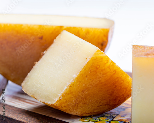 Hard Italian pecorino sheep cheese on wooden board photo