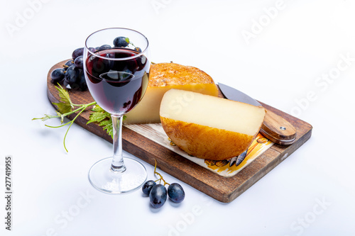 Hard Italian pecorino sheep cheese and glass with Italian red wine photo