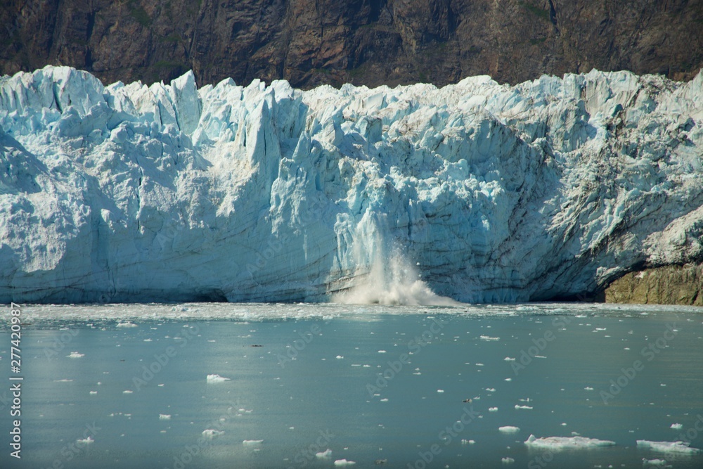 Chunk of Ice falling off Glacier, in Glacier Bay National Park and Preserve