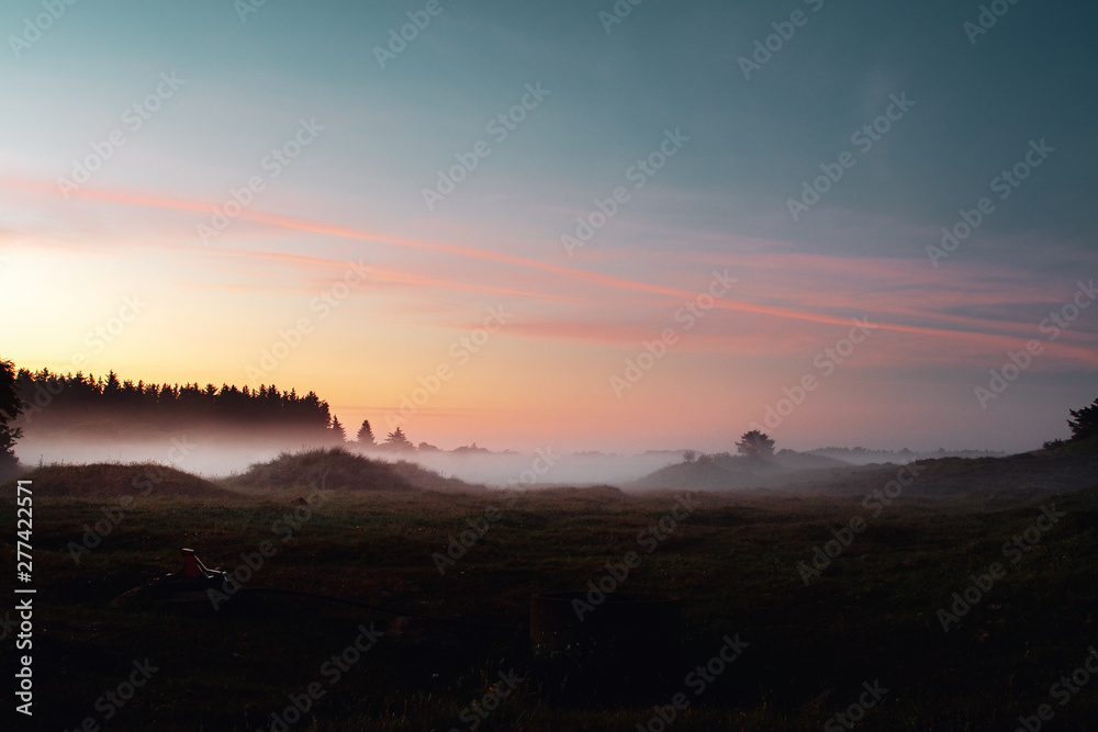 Beautiful natural morning light at dawn with fog meadows. Landscape countryside view of Denmark in Europe