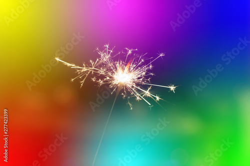 Sparks from hand cold fireworks colorful background
