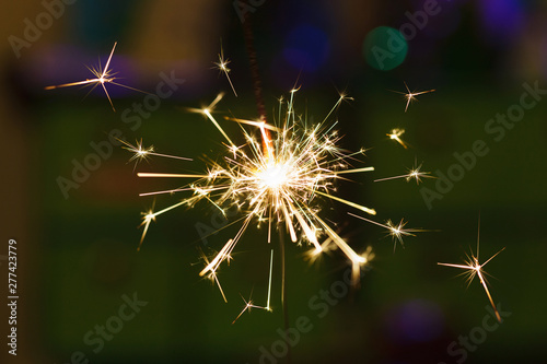Sparks from hand cold fireworks color background