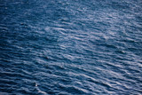 Blue water view from above. Deep blue color. Blue background.