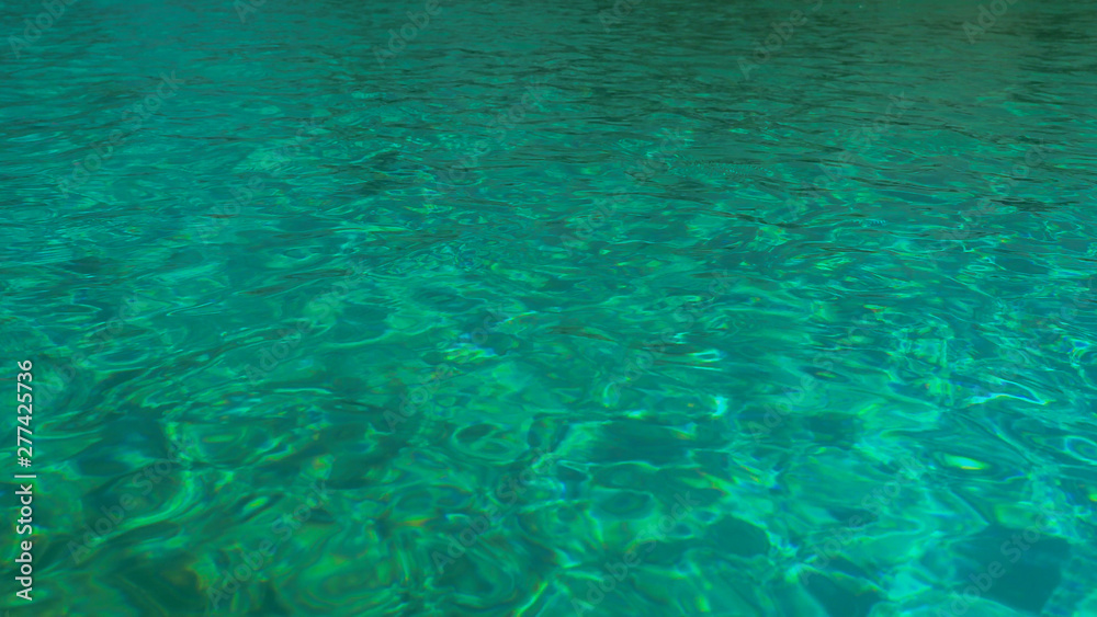 Water in the pool, sunlight is reflected, small waves, Shot from a tripod 4k video