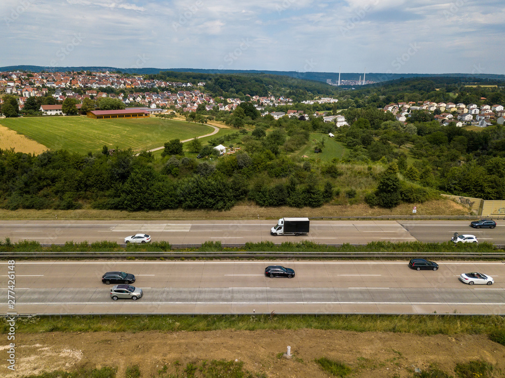 Aerial view of a German Autobahn at Denkendorf near Stuttgart - drone photo taken on a weekend, hence not much truck traffic Aerial view of a German Autobahn at Denkendorf near Stuttgart - drone photo taken on a weekend, hence not much truck traffic