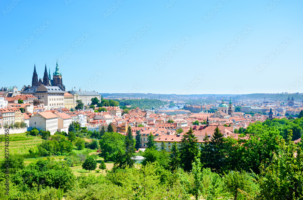 Amazing cityscape of Prague, Czech Republic captured from the Petrin hill with adjacent green park. The dominant of the Czech capital is gorgeous Prague Castle and Saint Vitus Cathedral. Skyline