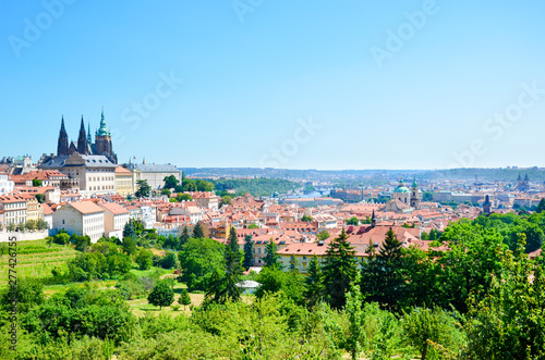 Amazing cityscape of Prague, Czech Republic captured from the Petrin hill with adjacent green park. The dominant of the Czech capital is gorgeous Prague Castle and Saint Vitus Cathedral. Skyline