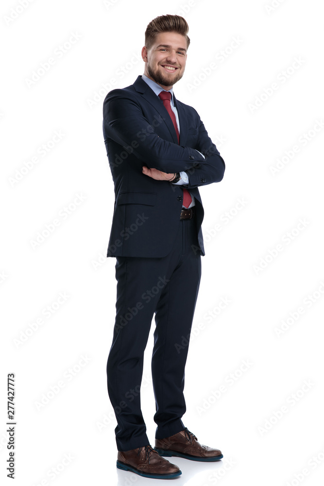 Joyful businessman standing with his arms folded and smiling Joyful businessman standing with his arms folded and smiling