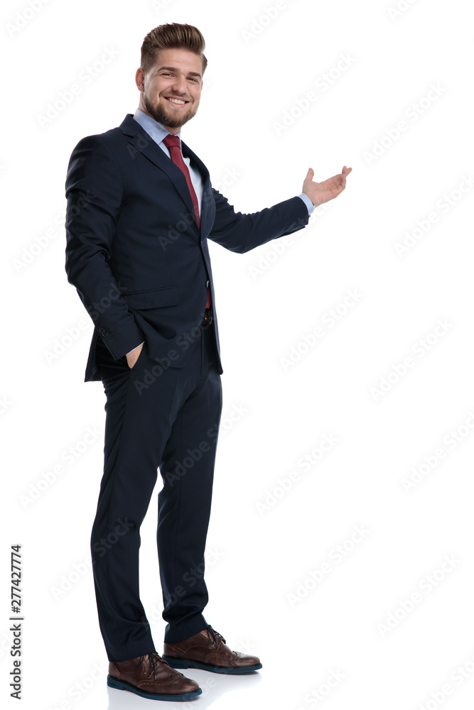 Positive businessman presenting and holding his hand in his pocket Positive businessman presenting and holding his hand in his pocket