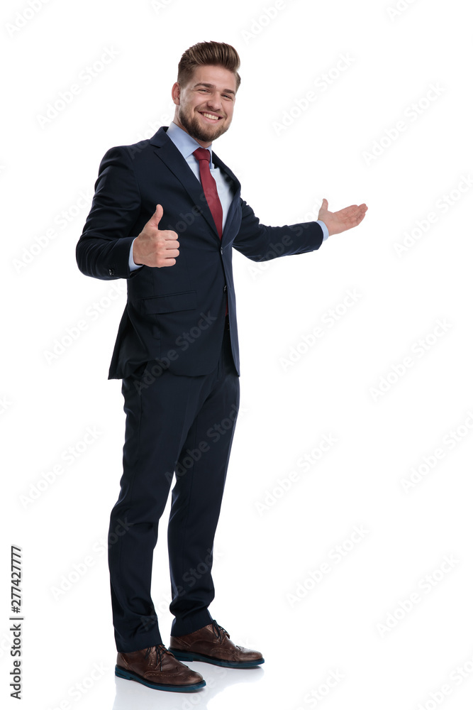 Happy businessman gesturing ok and presenting while laughing Happy businessman gesturing ok and presenting while laughing