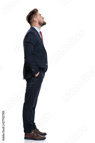 Side view of a hopeful businessman looking up