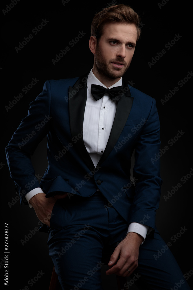 Upset groom holding his hand in his pocket Upset groom holding his hand in his pocket