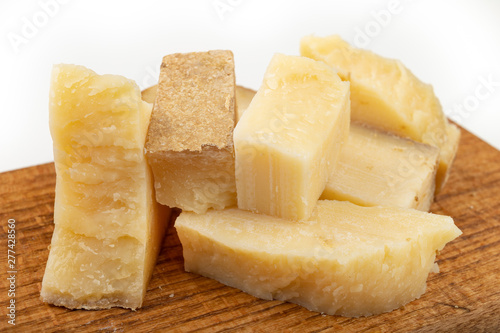 Tasty cheese on a dark kitchen plank. Snacks to beer on a white table in the home kitchen.