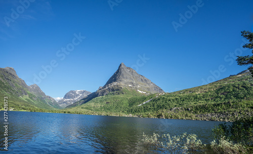 Panoramic view over the lake at Innerdalstarnet  also called Dalatarnet  peak - a 1 452-metre  4 764 ft  sharp pyramidical mountain in the Sunndalen valley. It is called Norwegian Matternhorn. Norway.