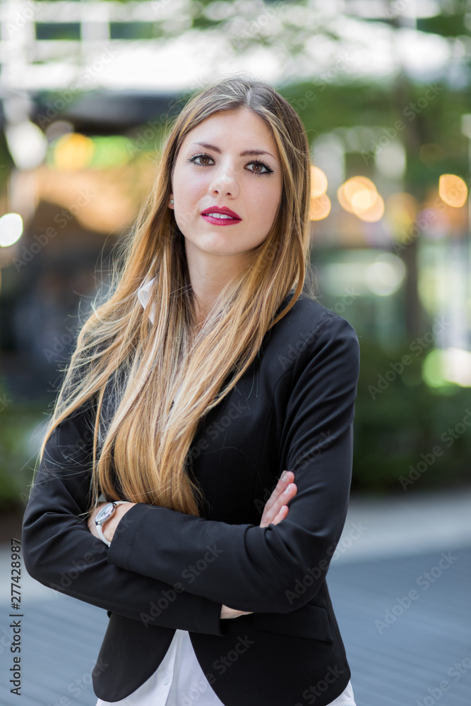 Confident young female manager outdoor in a modern urban setting Confident young female manager outdoor in a modern urban setting