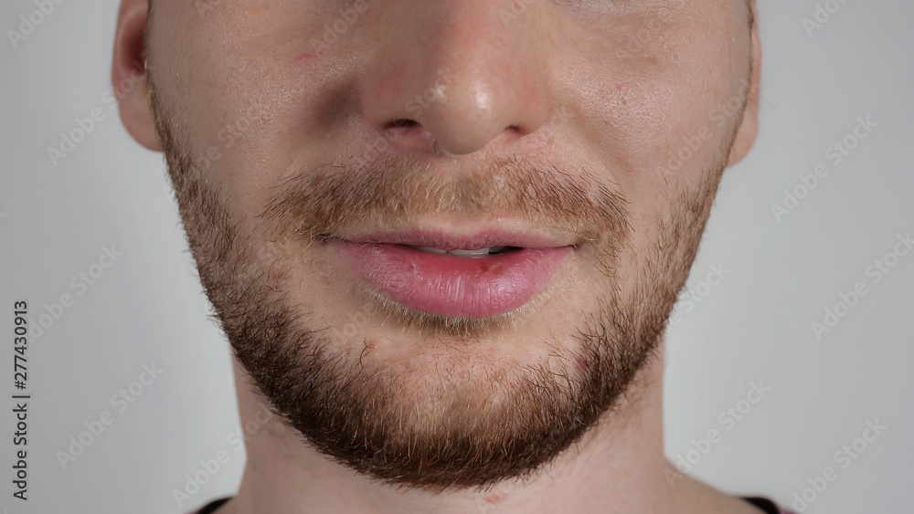 close up part of face young caucasian man with beard and bristle