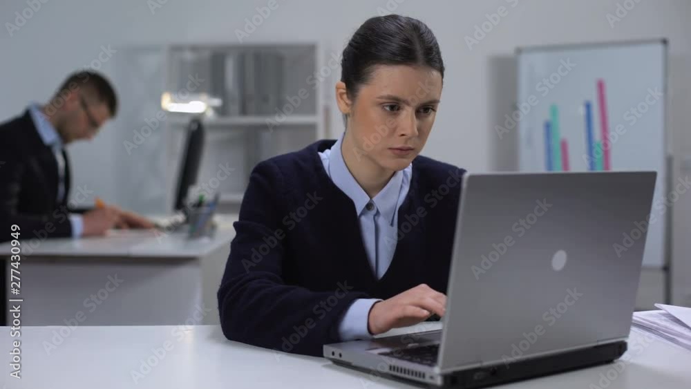 Focused female manager working on laptop, texting e-mail to business partners Focused female manager working on laptop, texting e-mail to business partners
