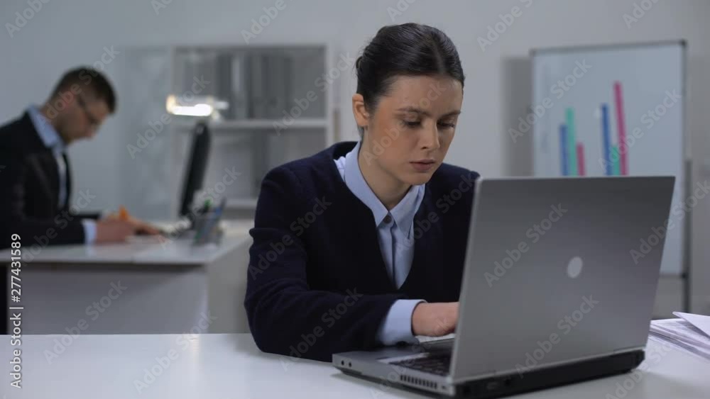 Concentrated female manager texting on laptop, workday in office, project Concentrated female manager texting on laptop, workday in office, project
