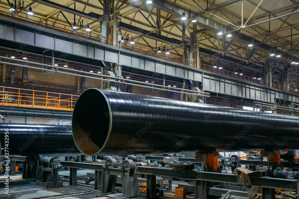 Pipe factory production line, coated pipe moving on roller conveyor Pipe factory production line, coated pipe moving on roller conveyor