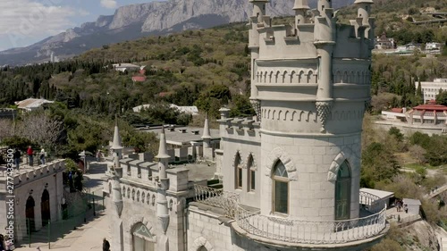 Aerial drone footage of Castle Swallow's Nest on a rock at Black Sea, Crimea. Castle is located in the urban area of Gaspra, Yalta